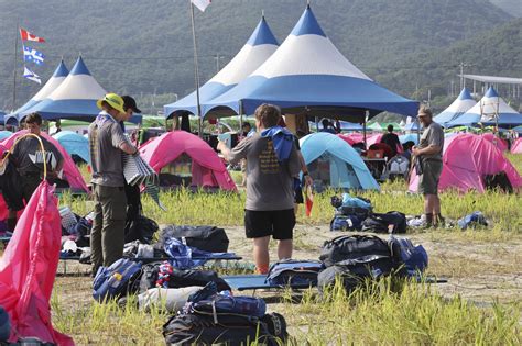 Tens of thousands of young scouts to leave world jamboree in South Korea as storm Khanun looms